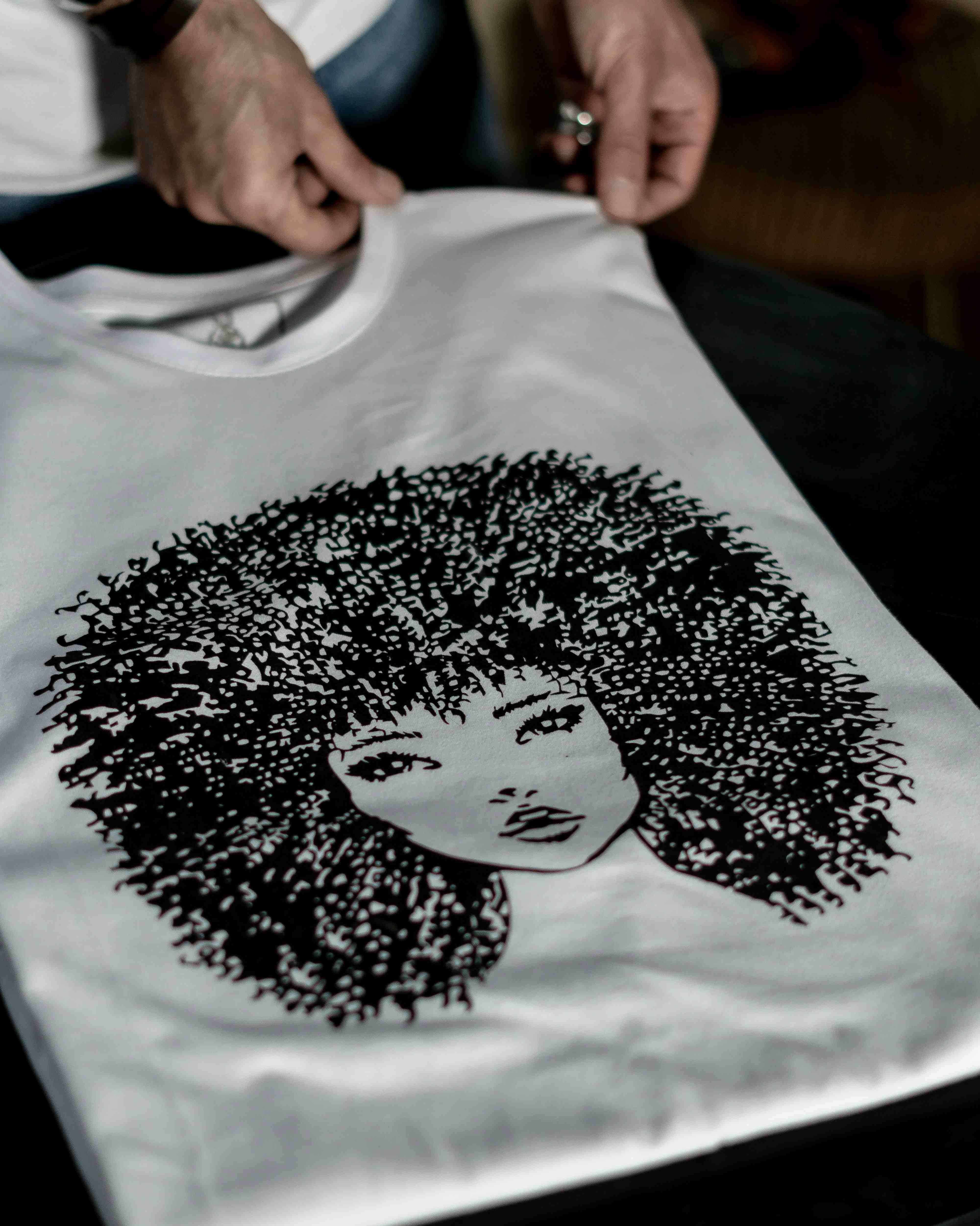 Detailed screen print of woman with afro on white shirt
