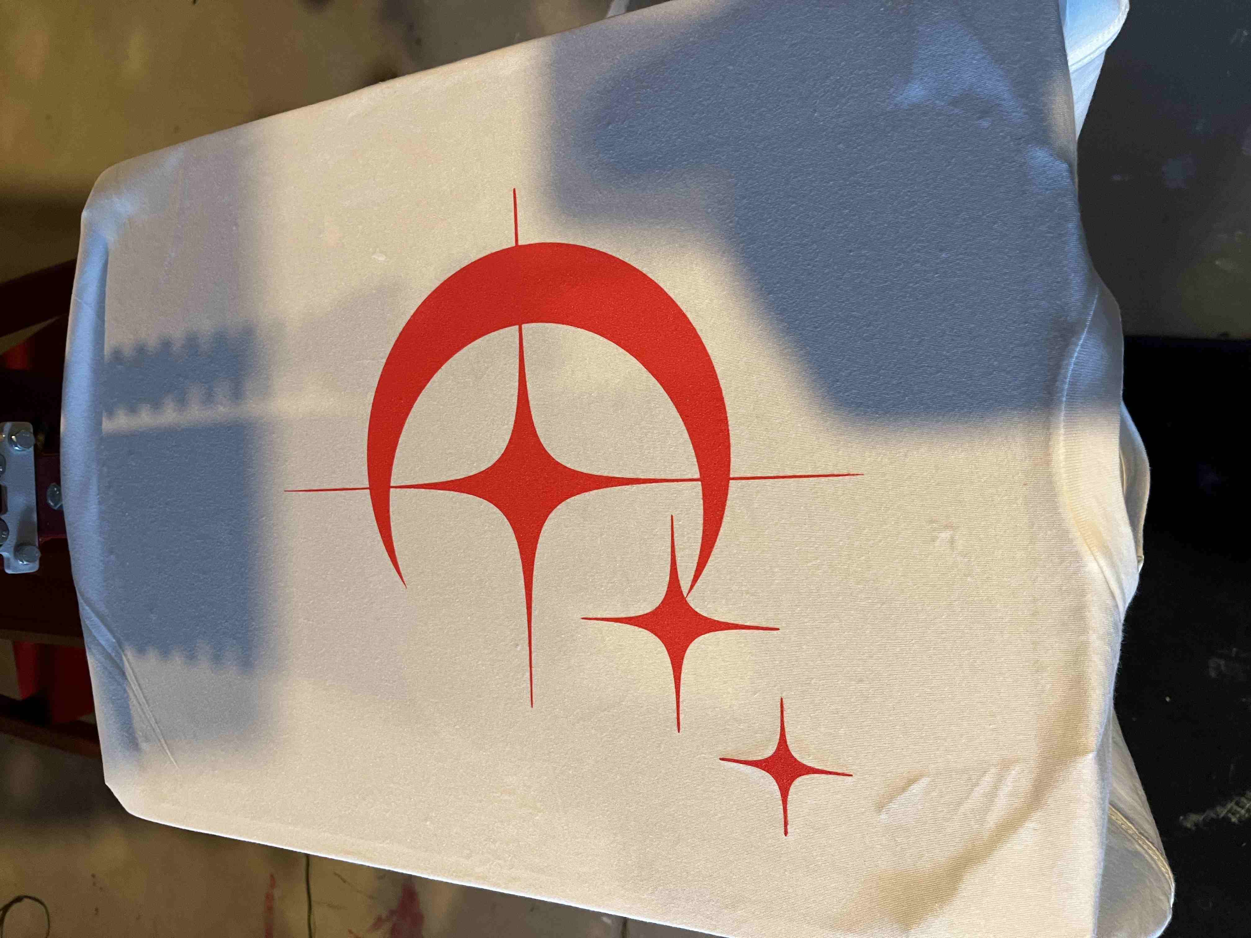A red crescent design being screen printed on the press at ARK